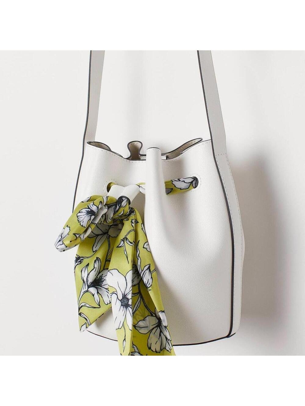 Minimal white bucket bag with removable floral scarf detail
